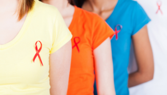 red ribbons pinned on colorful shirts