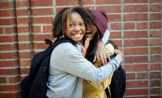 two teens hugging