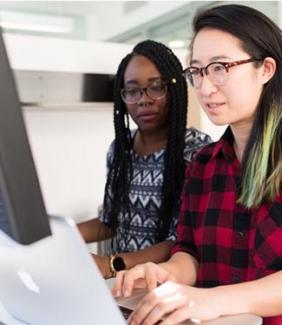 two people looking at a computer together