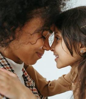 mother and child smiling and pressing their faces together