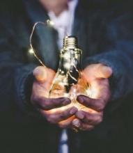 hands holding lightbulb